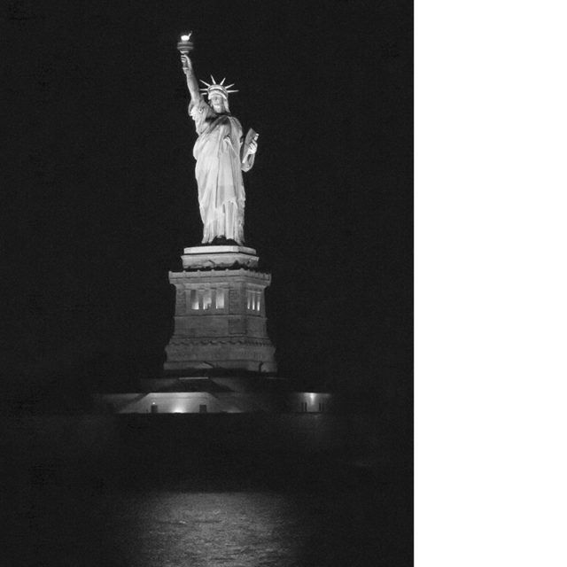 The Statue of Liberty, seen from New York Harbor at night. August 2016